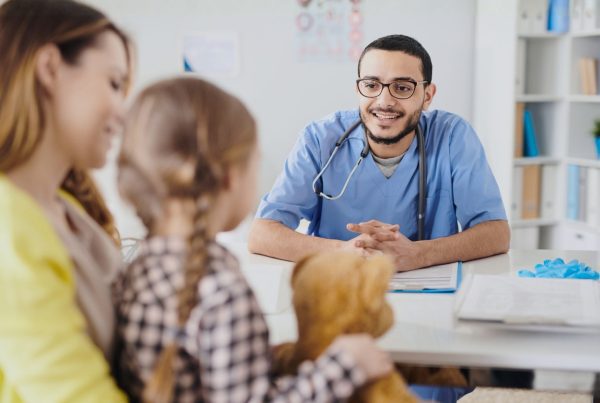 Mother and child talking to GP about bedwetting