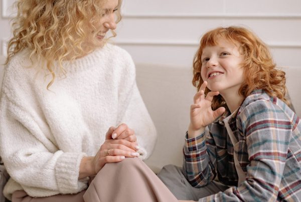 A mother and child having a positive, supportive discussion about growing out of bedwetting. Image in reference to the educational blog by Treatbedwetting.